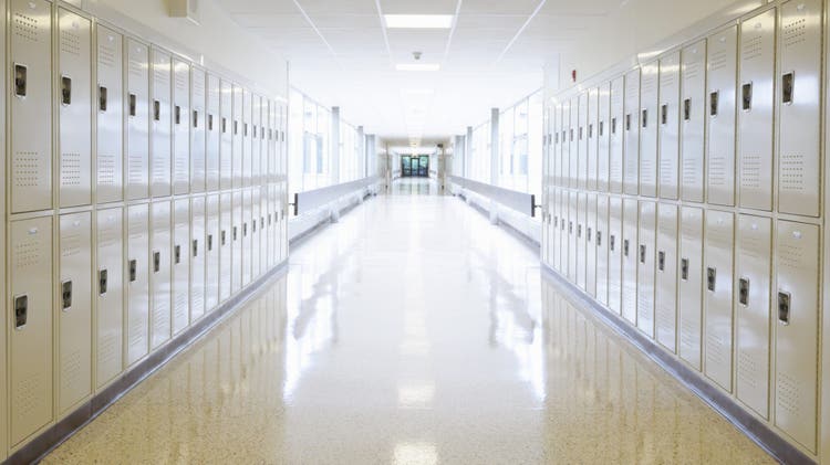 High School hallway empty with lockers and bright vanishing point