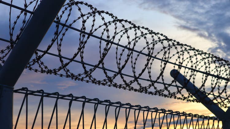 Barbed Wire Against Sunset Sky Background