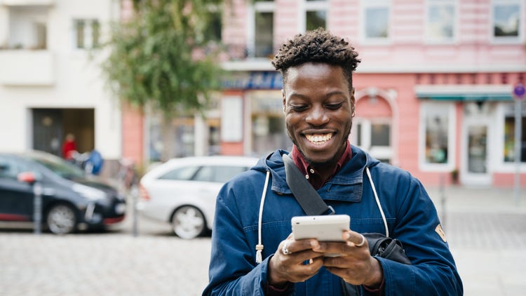 Man smiling at smart phone