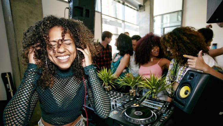 Black woman DJ at party