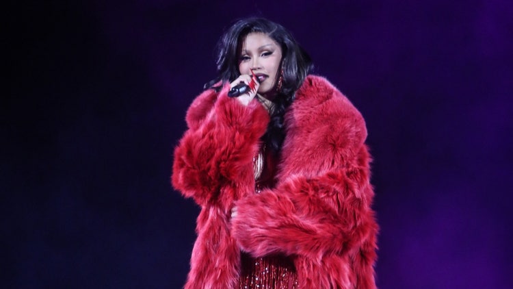 A person in a red fur coat Description automatically generated