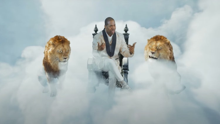 A person sitting on a chair with two lions in the clouds Description automatically generated